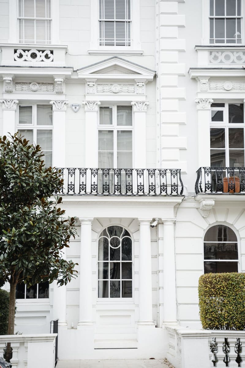 White stucco townhouse with ironwork balconies
