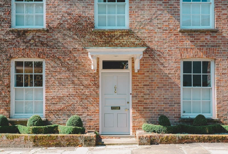 Georgian brick house with a freshly painted pale blue front door